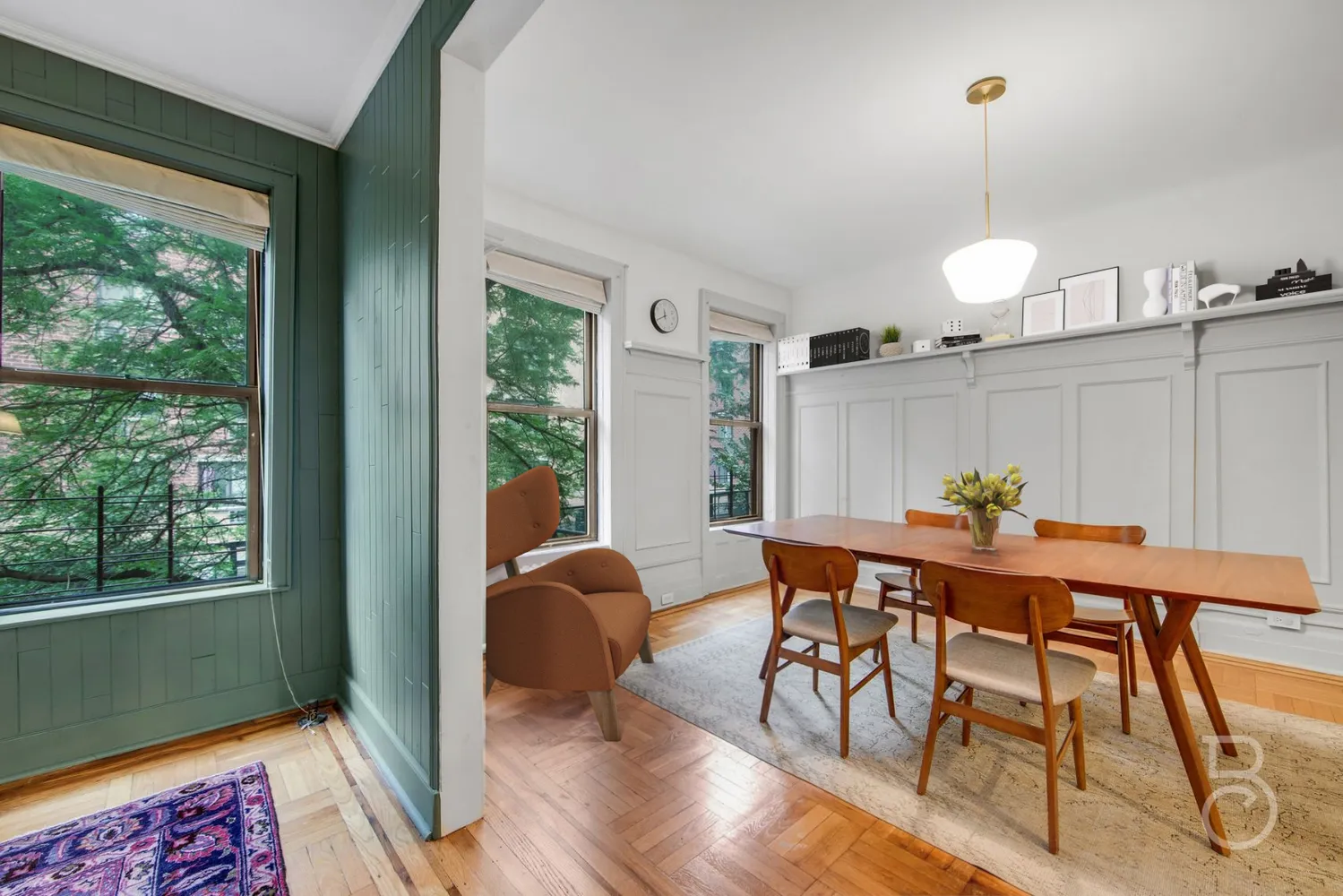 a dining room filled chandelier and wooden floor