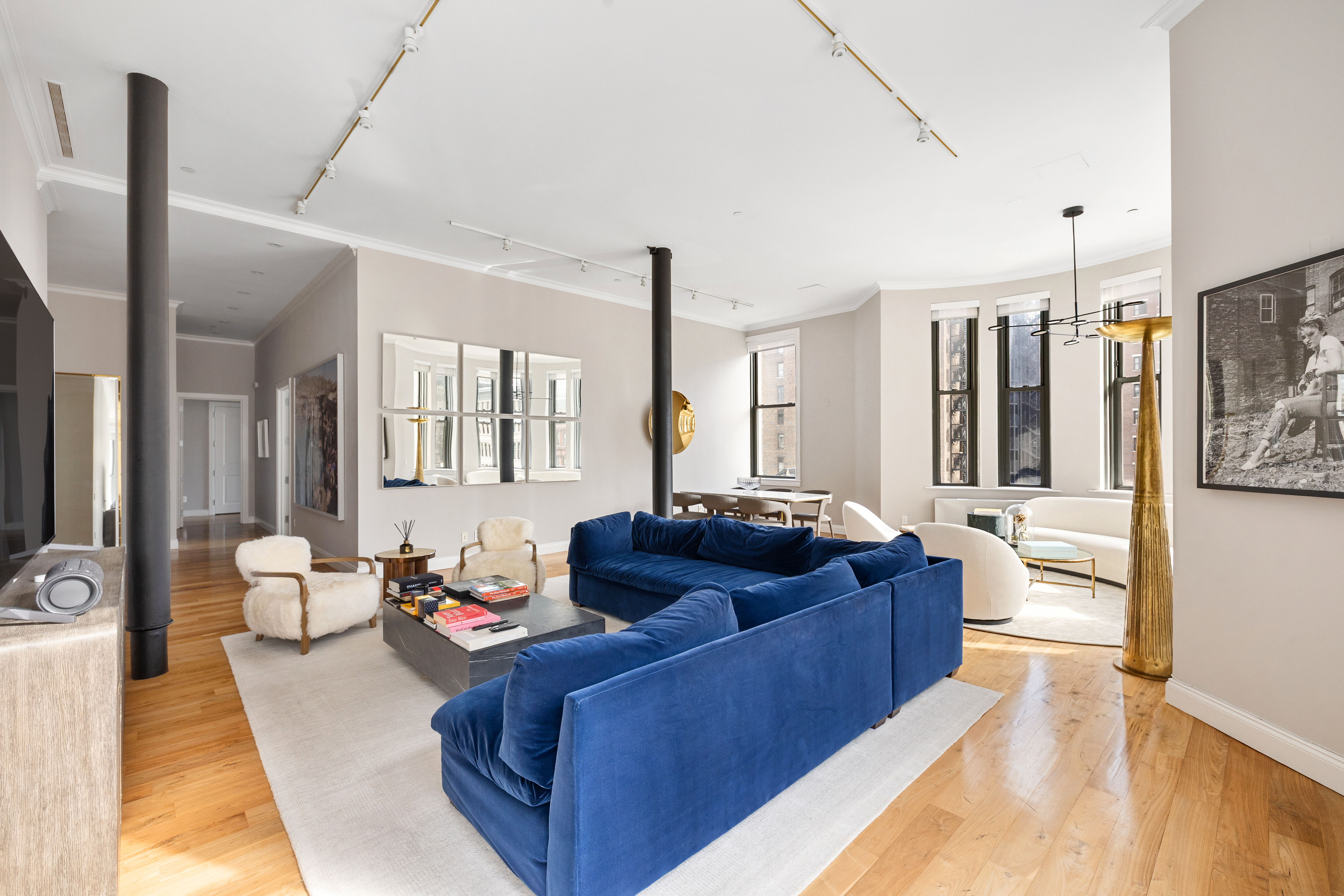 655 6th Avenue, Unit 5E Manhattan, NY 10010 - Photo 4 of 15 a living room with furniture and a flat screen tv
