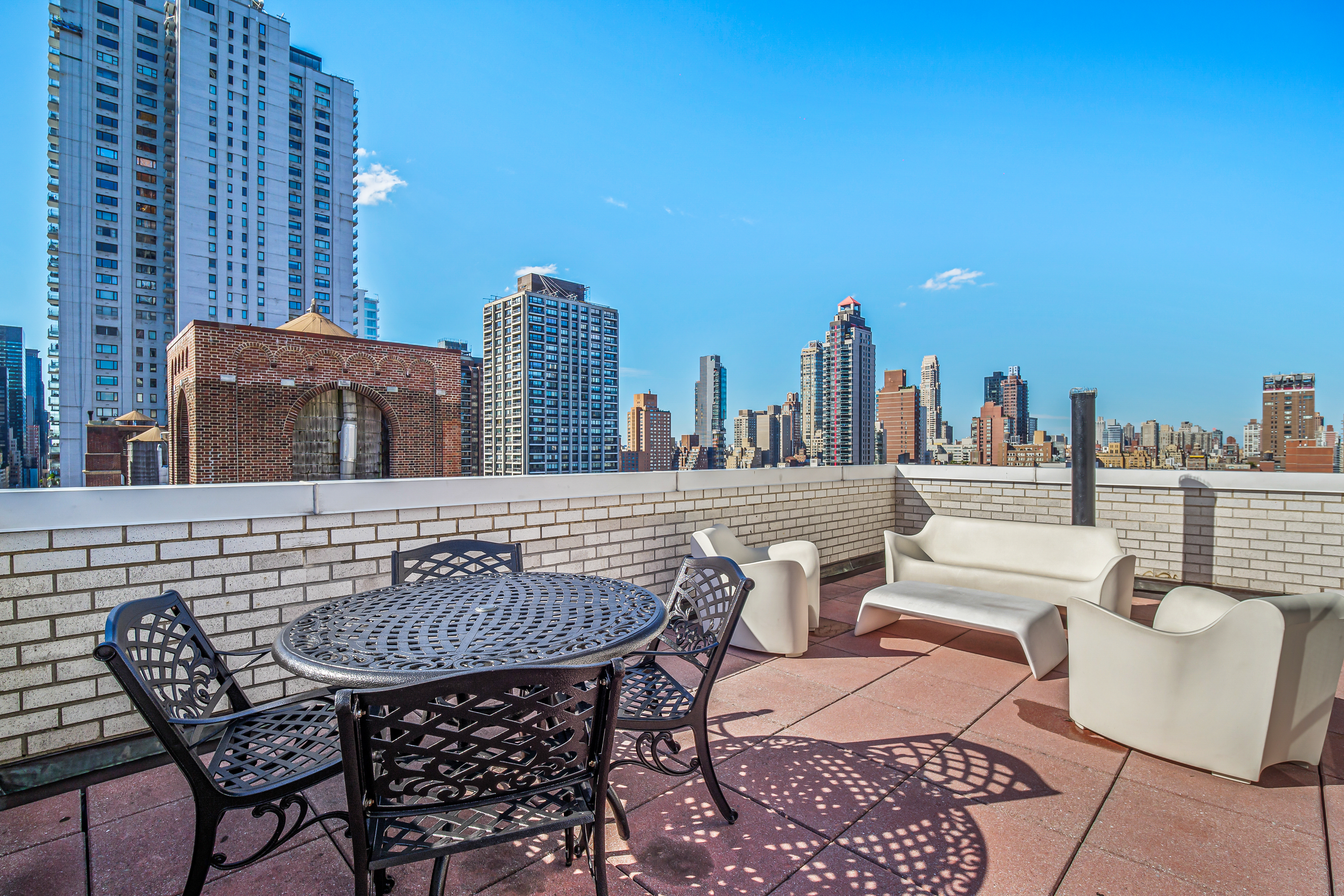 357 East 57th Street, Unit 10C Manhattan, NY 10022 - Photo 9 of 12 a view of a terrace with furniture and a fire pit