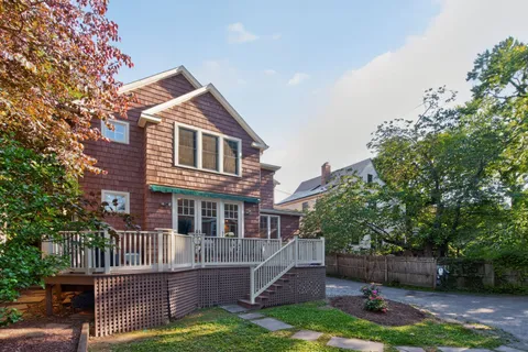 a view of a house with a yard and fence