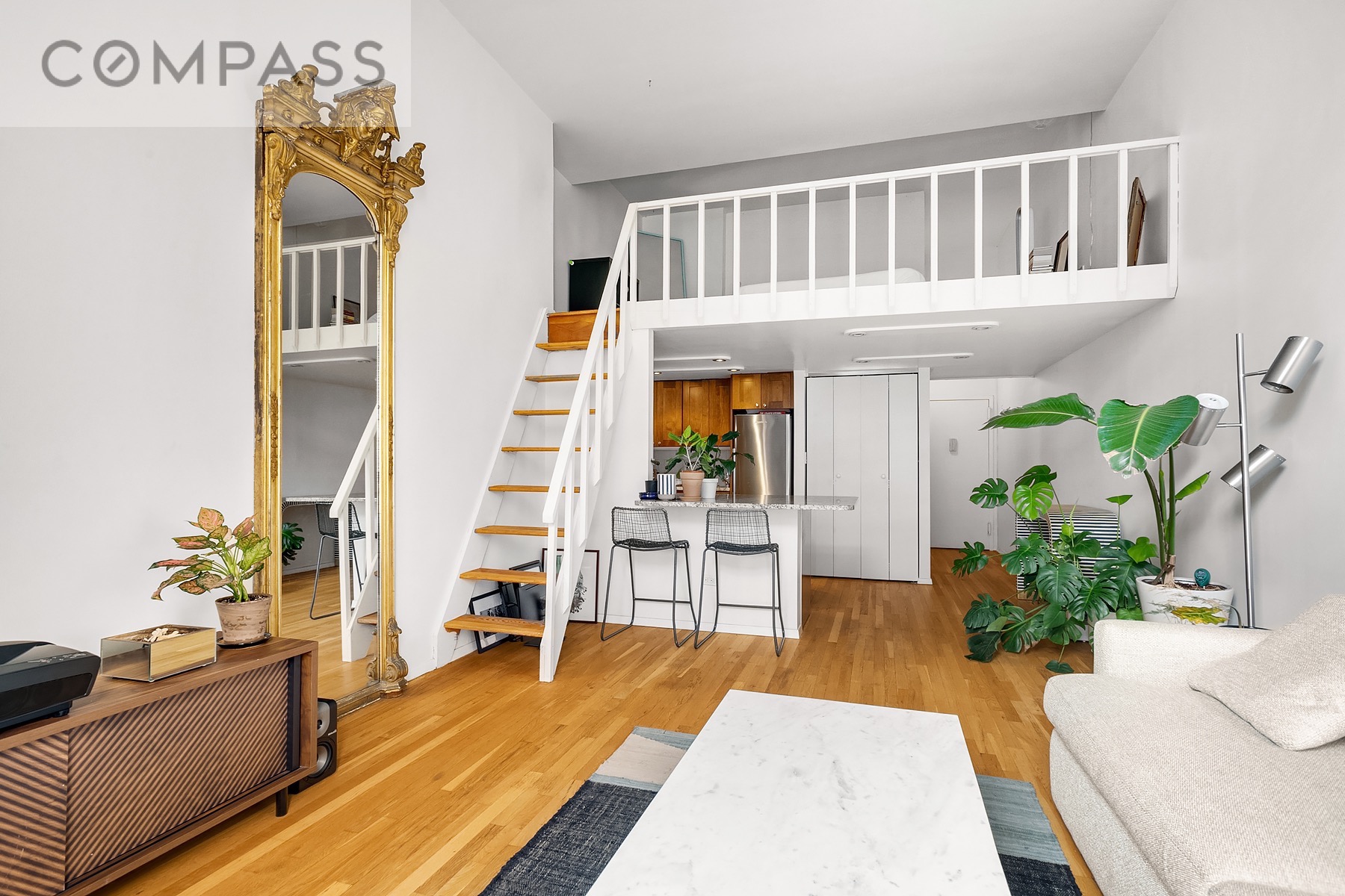 250 Mercer Street, Unit C309 Manhattan, NY 10012 - Photo 1 of 8 a living room with furniture and a table