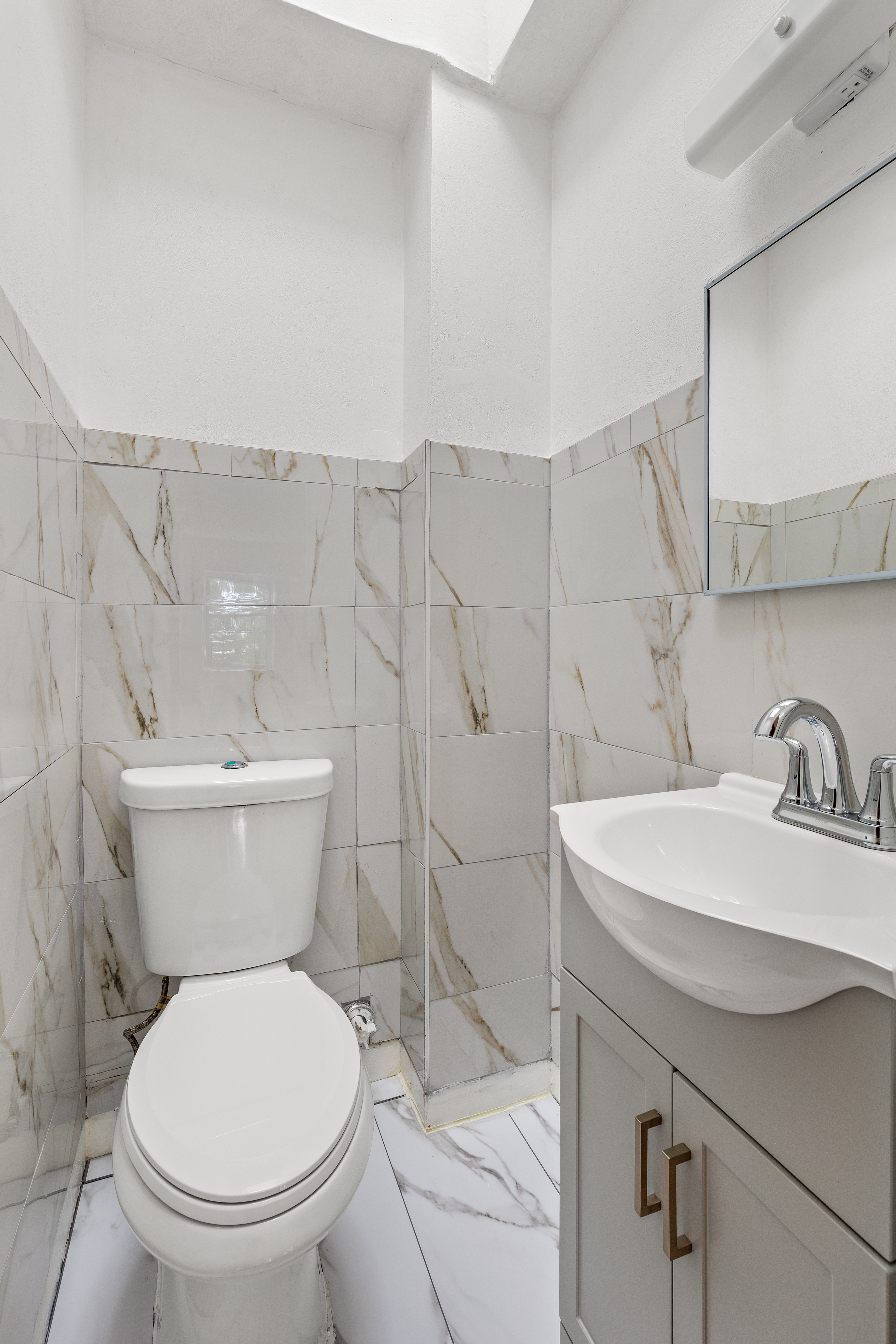 701 Rockaway Parkway, Unit 2F Brooklyn, NY 11236 - Photo 8 of 9 a bathroom with a toilet sink and a mirror