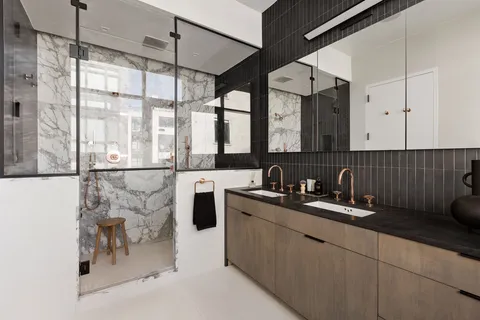 a kitchen with a sink a counter top space and a refrigerator