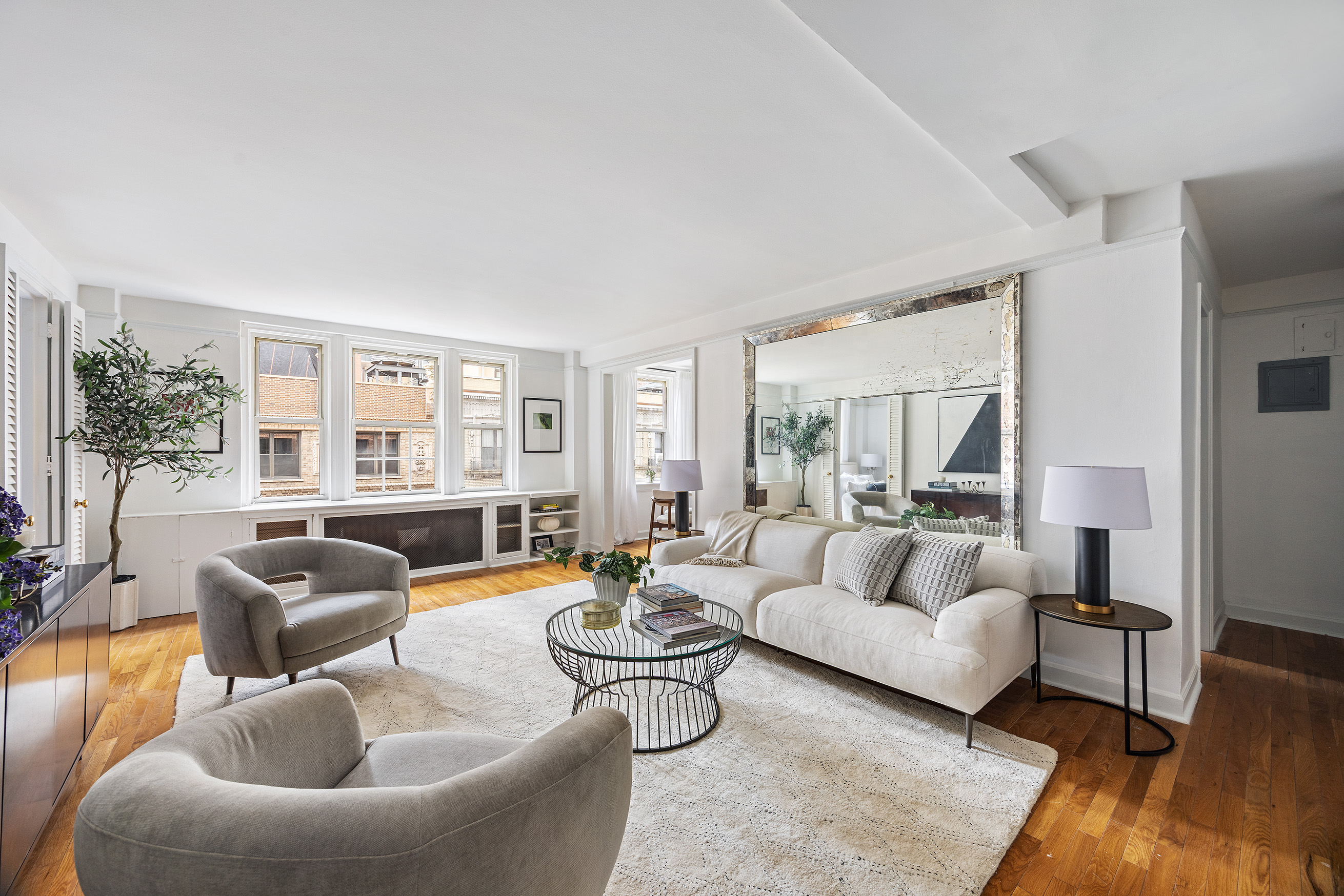 155 East 49th Street, Unit 10A Manhattan, NY 10017 - Photo 2 of 16 a living room with furniture and a large window