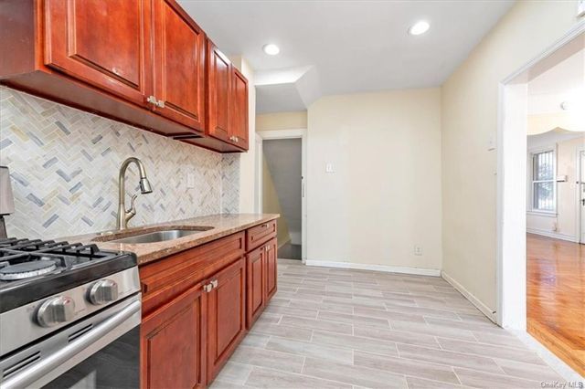 1186 Brooklyn Avenue, Unit N A Brooklyn, NY 11203 - Photo 15 of 17 a kitchen with stainless steel appliances granite countertop a stove and a refrigerator