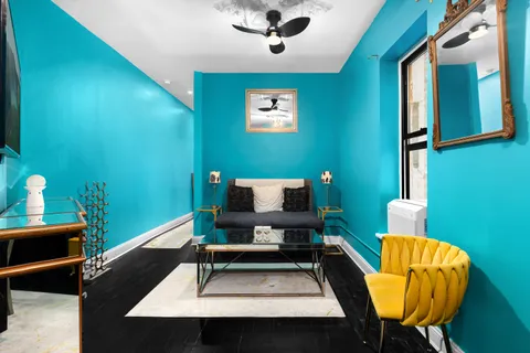 a living room with a table chairs and a wooden floor