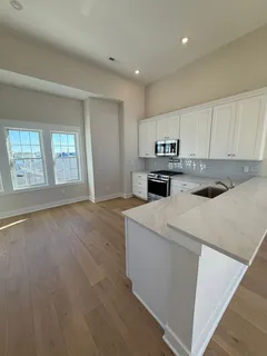 a kitchen with a stove a sink and a refrigerator