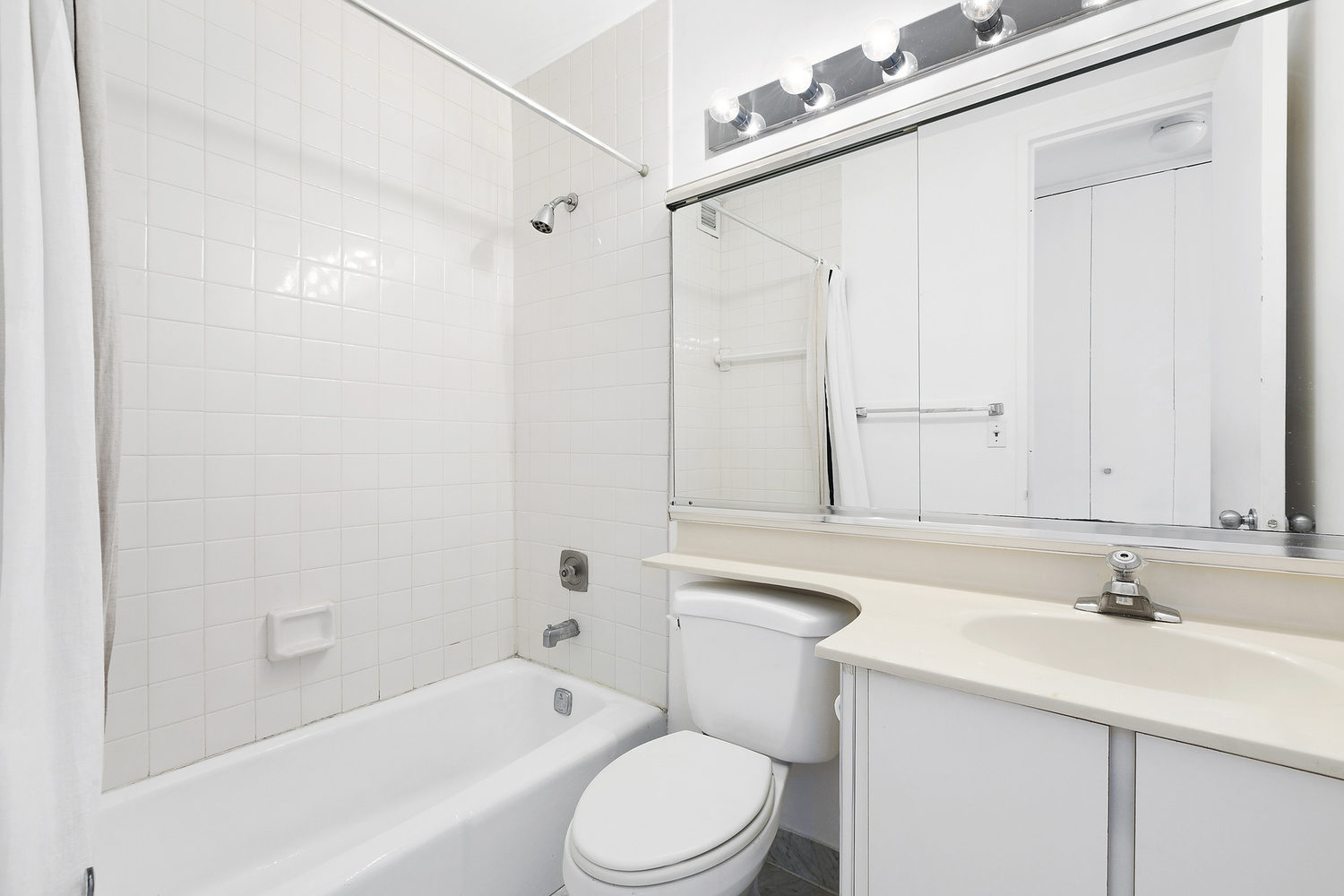 5 East 22nd Street, Unit 28M Manhattan, NY 10010 - Photo 7 of 11 a bathroom with a sink a toilet and shower