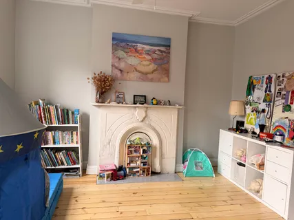 a view of a workspace with furniture and a book shelf