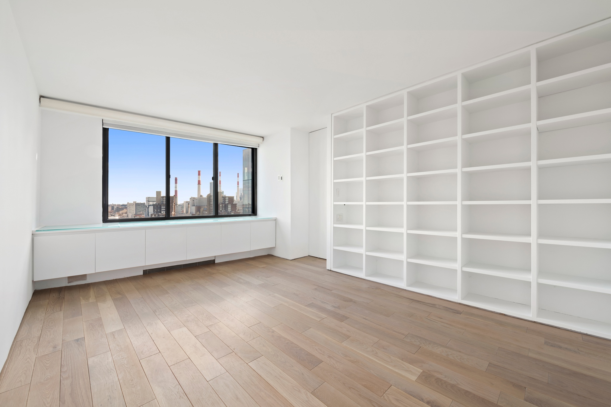 530 East 72nd Street, Unit 14E Manhattan, NY 10021 - Photo 13 of 19 a view of an empty room with wooden floor and a window