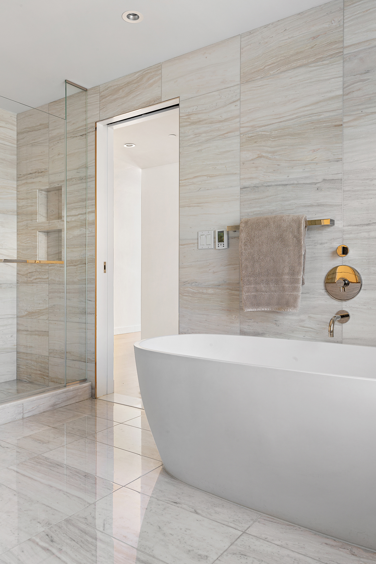 135 West 52nd Street, Unit PH3 Manhattan, NY 10019 - Photo 11 of 17 a bathroom with a bathtub and shower