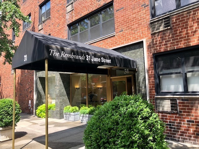 31 Jane Street, Unit 5A Manhattan, NY 10014 - Photo 11 of 13 a view of a brick building with a large windows