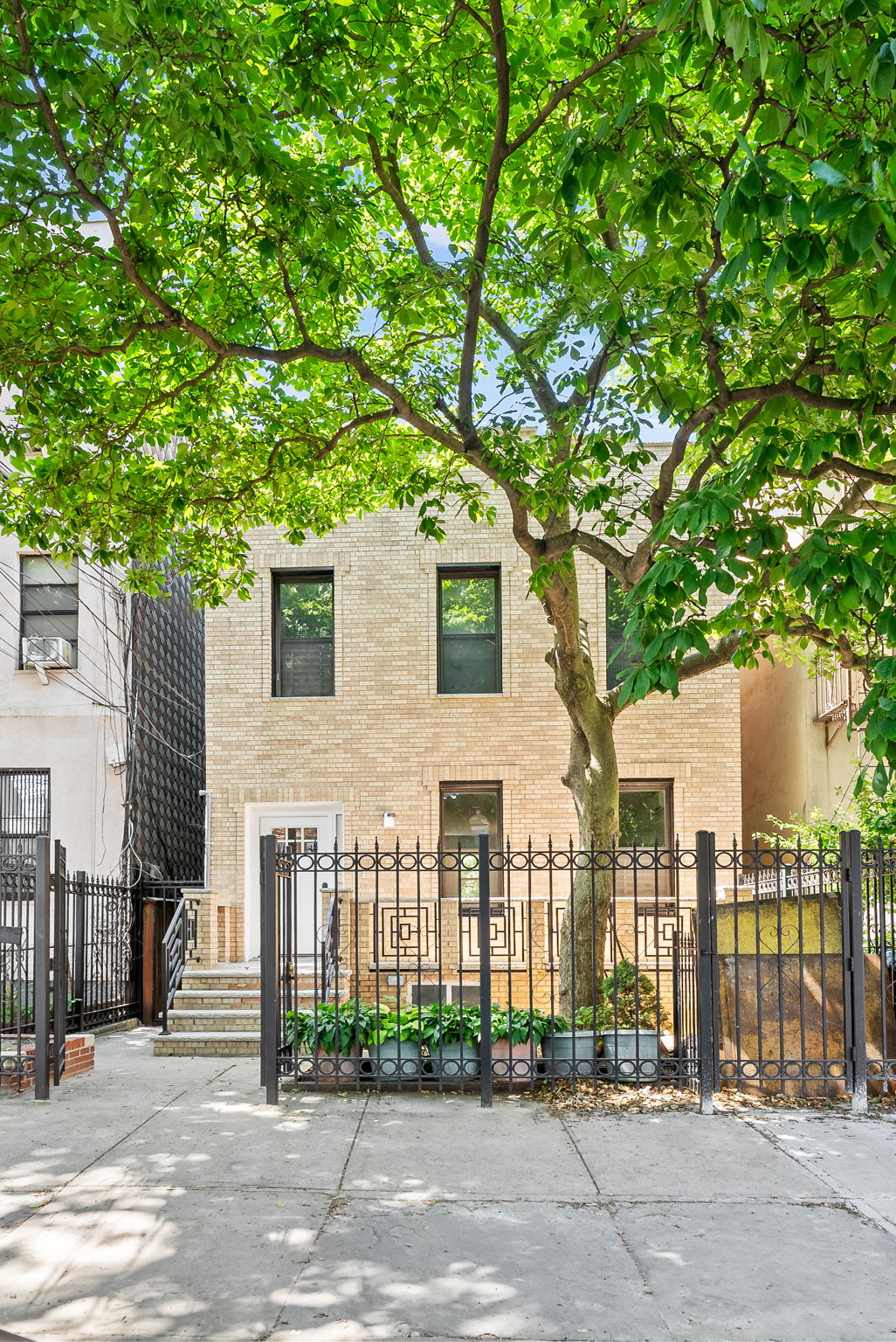 1414 30th Road Queens, NY 11102 - Photo 15 of 16 a front view of a house with a tree