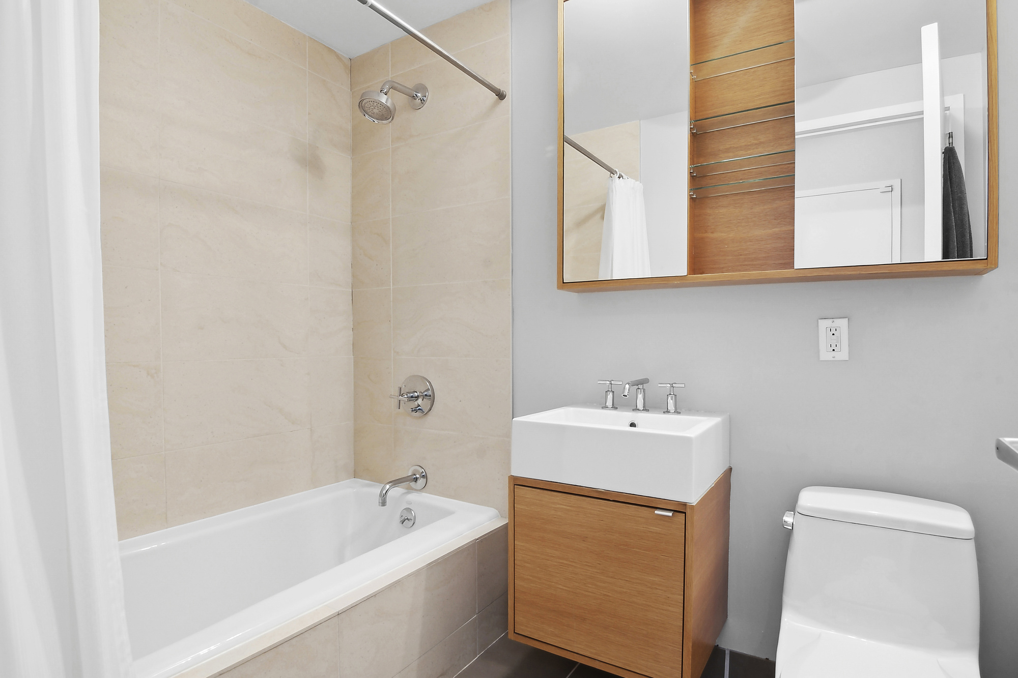 364 Manhattan Avenue, Unit 4G Brooklyn, NY 11211 - Photo 9 of 13 a bathroom with a sink a mirror and a bathtub