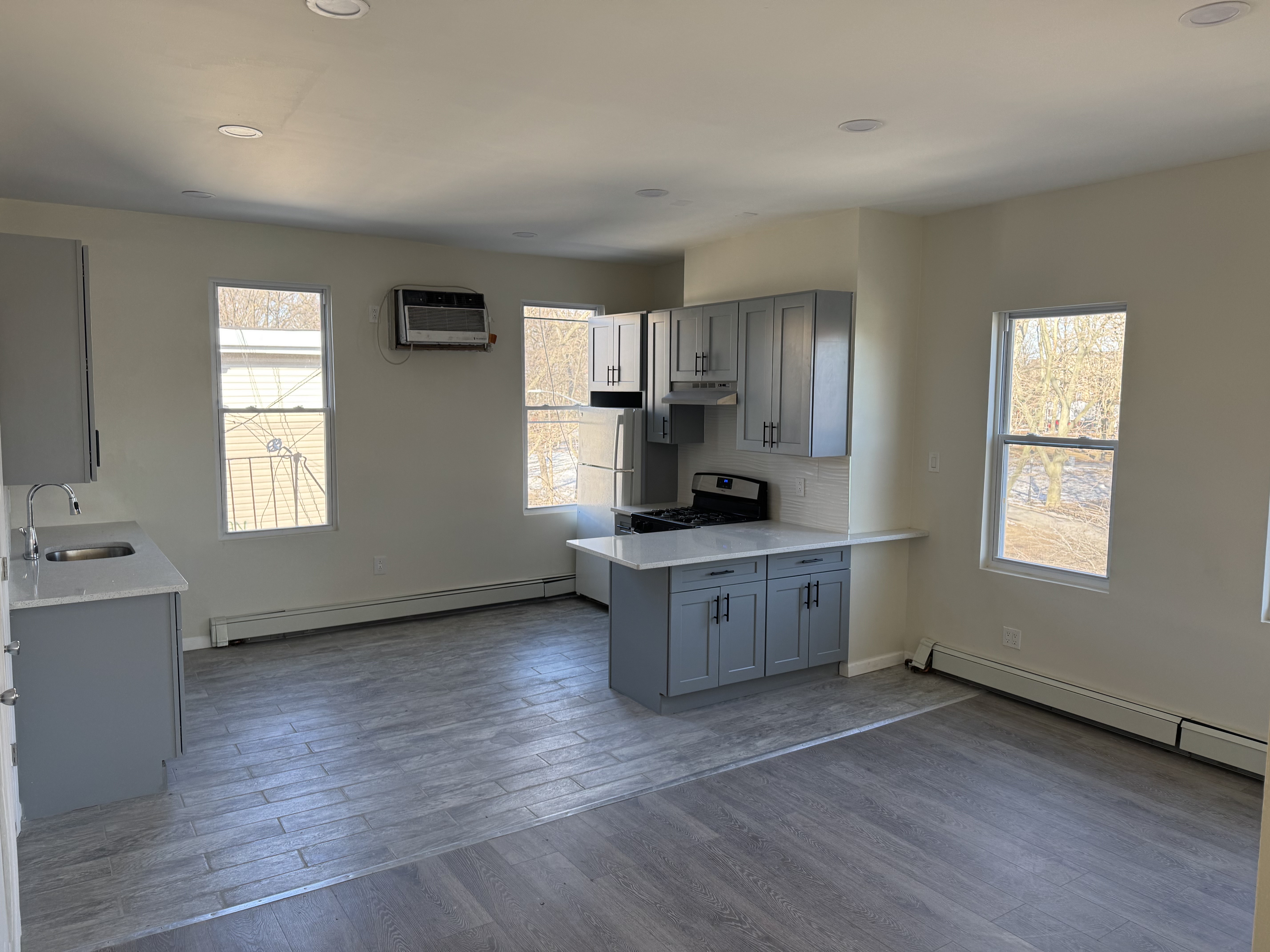 142 Driggs Avenue, Unit 3 Brooklyn, NY 11222 - Photo 3 of 8 a kitchen with sink cabinets and window