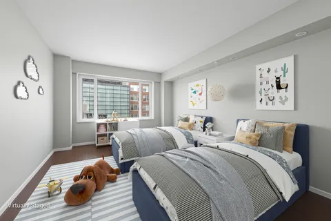 a bedroom with two beds and a window with outer view