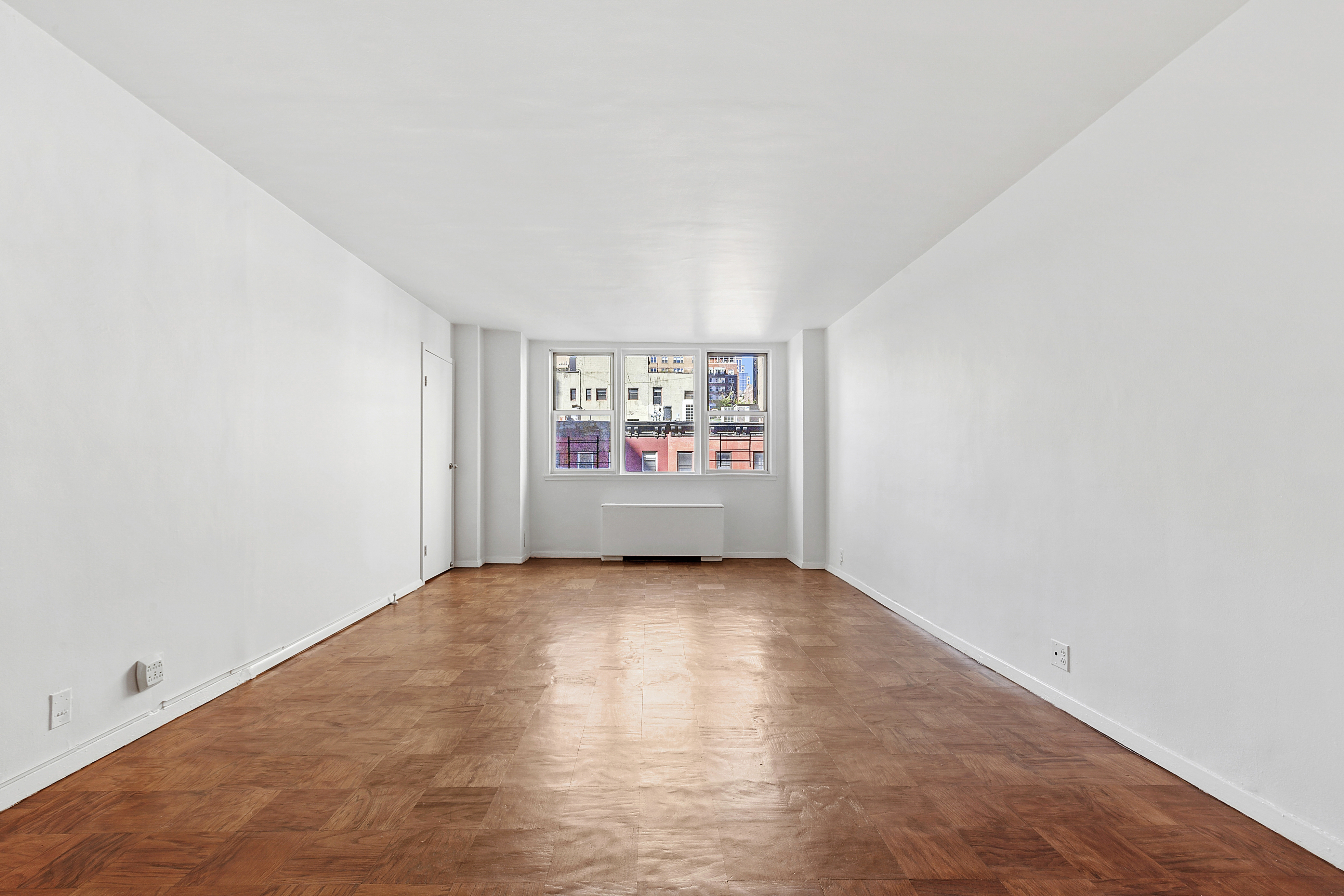 201 East 36th Street, Unit 5D Manhattan, NY 10016 - Photo 2 of 9 a view of an empty room and a window