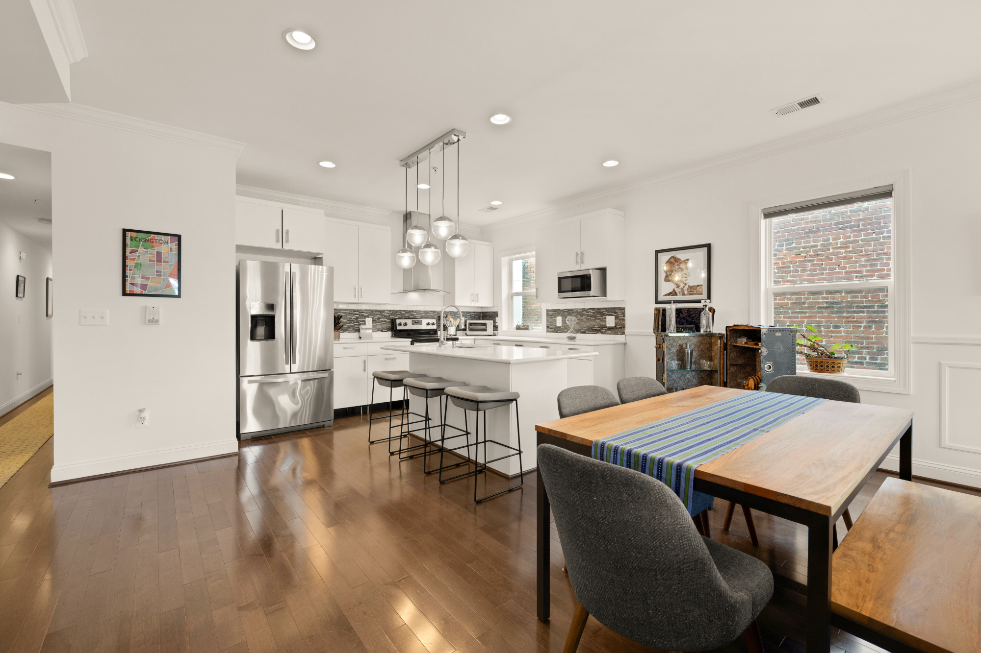 233 S Street Northeast, Unit 4 Washington, DC 20002 - Photo 9 of 37 a open kitchen with white cabinets and stainless steel appliances