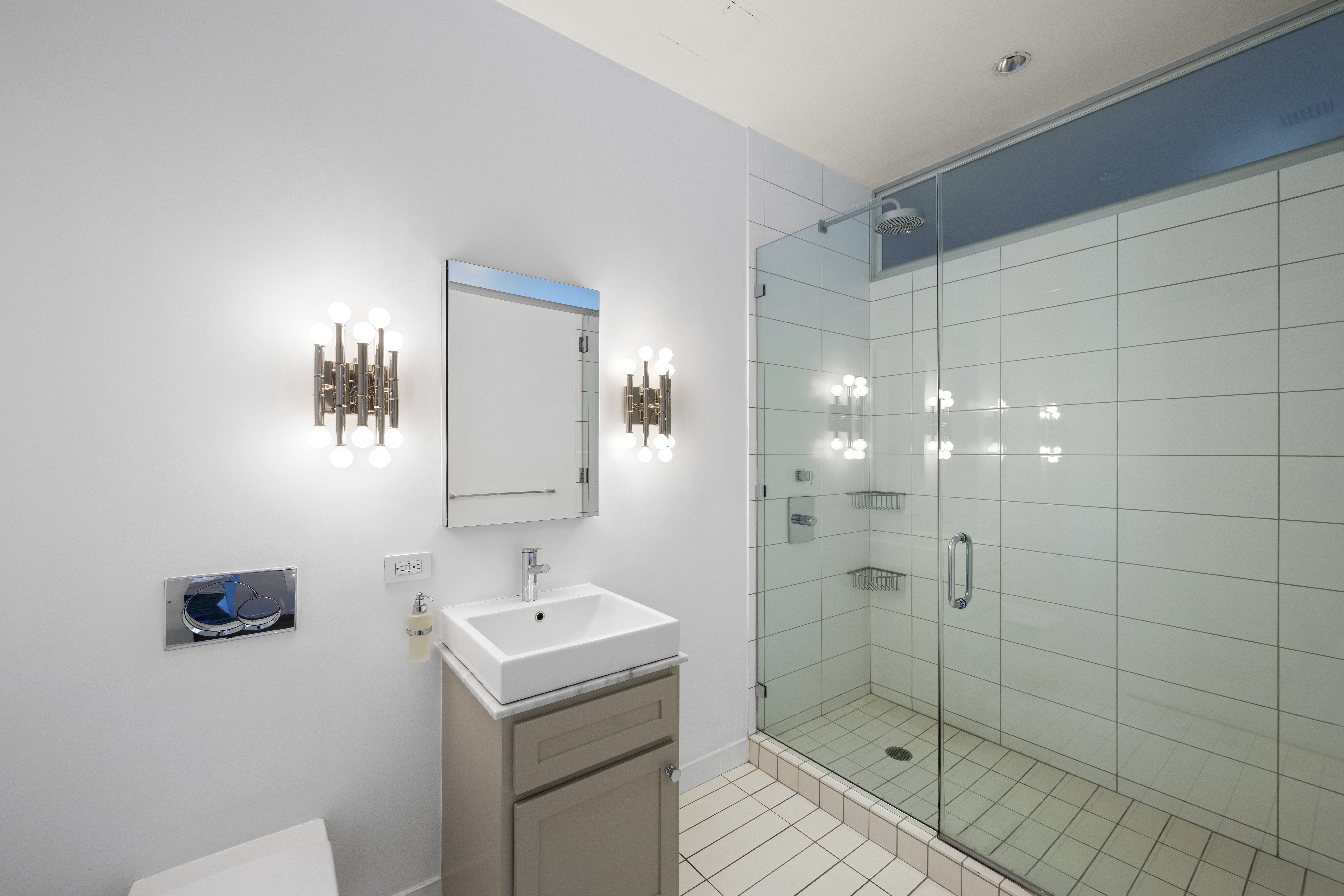 60 West 20th Street, Unit 2F Manhattan, NY 10011 - Photo 12 of 21 a bathroom with a shower a sink and mirror