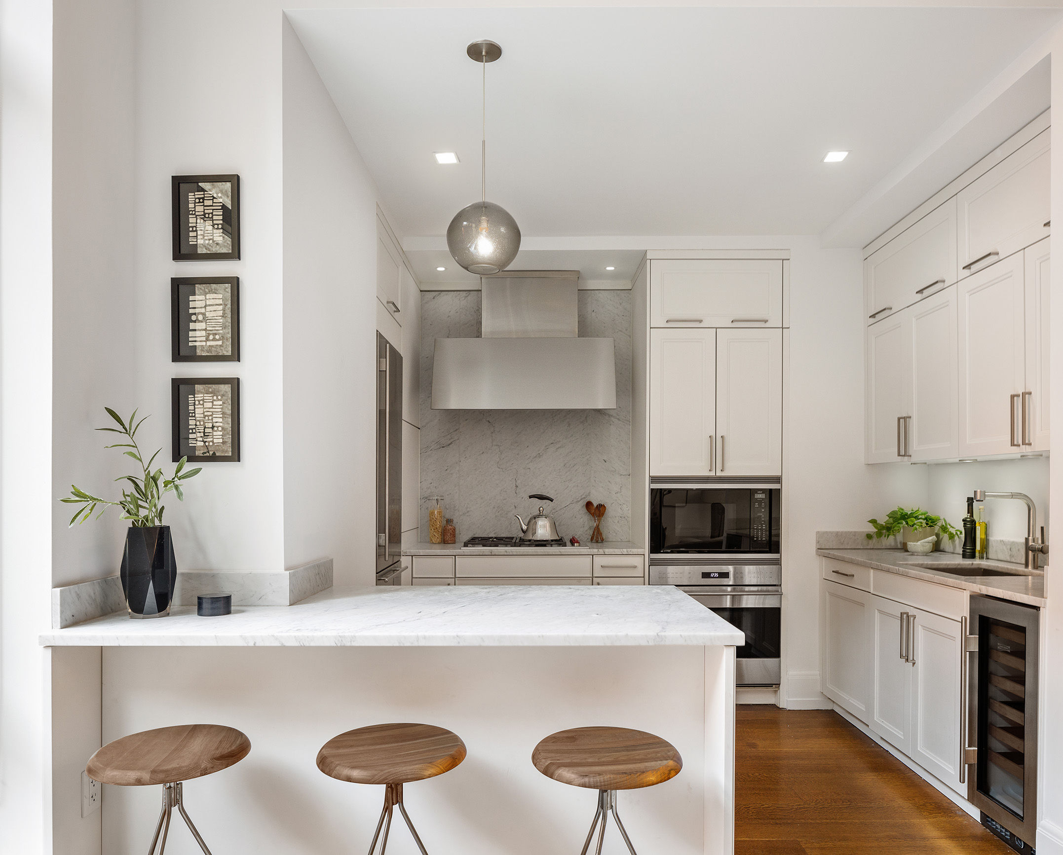 10 Madison Square West, Unit 7A Manhattan, NY 10010 - Photo 4 of 8 a kitchen with a stove and white cabinets