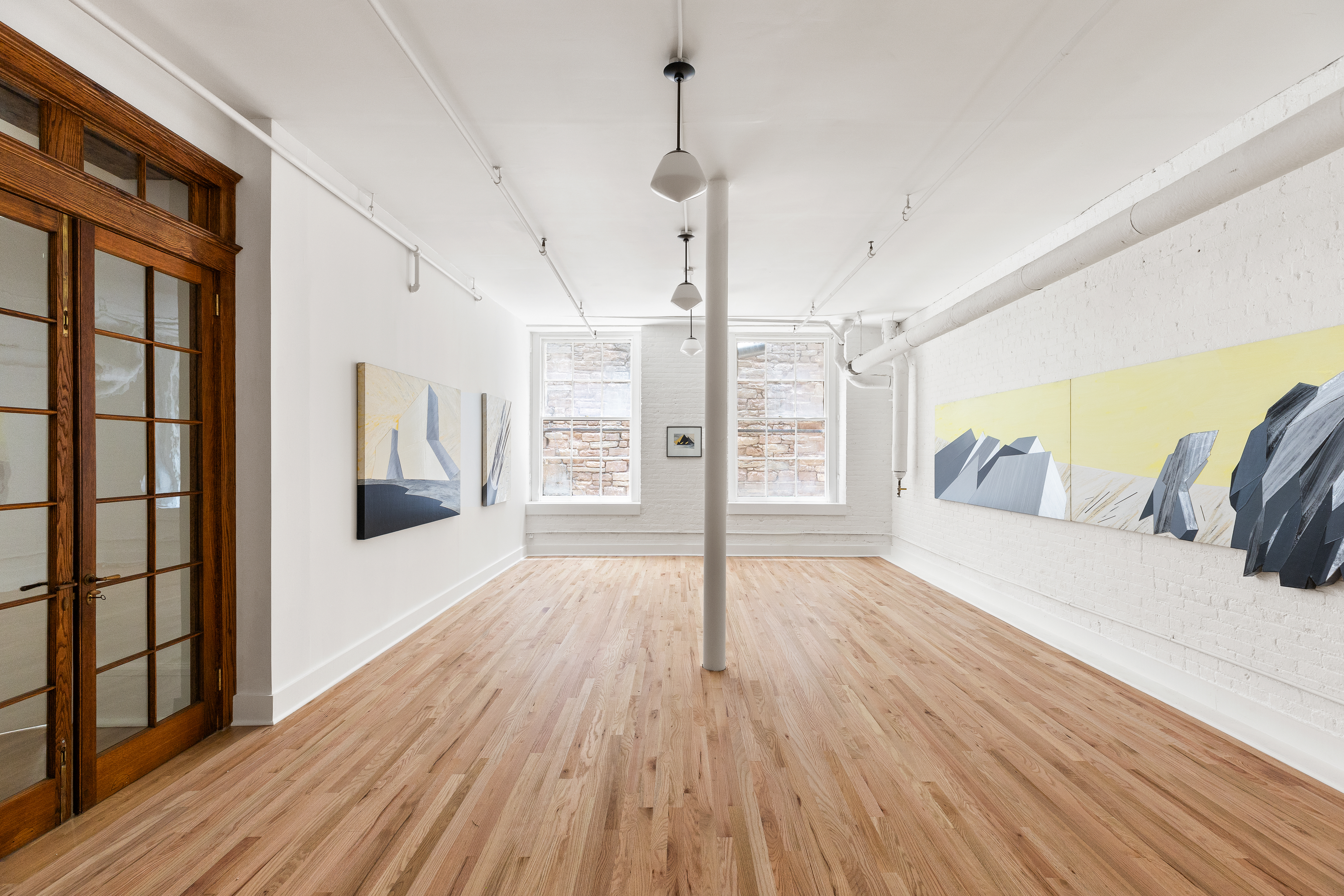 144 Franklin Street, Unit B Manhattan, NY 10013 - Photo 9 of 14 a view of a bedroom with wooden floor and windows