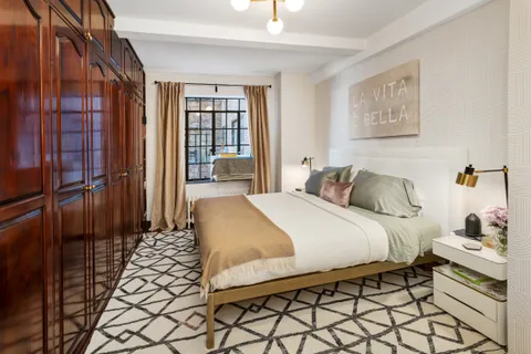 a bedroom with a bed and a cabinets