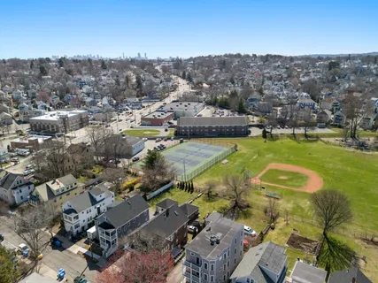 an aerial view of residential houses with outdoor space