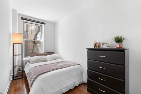 a bedroom with a bed and a window