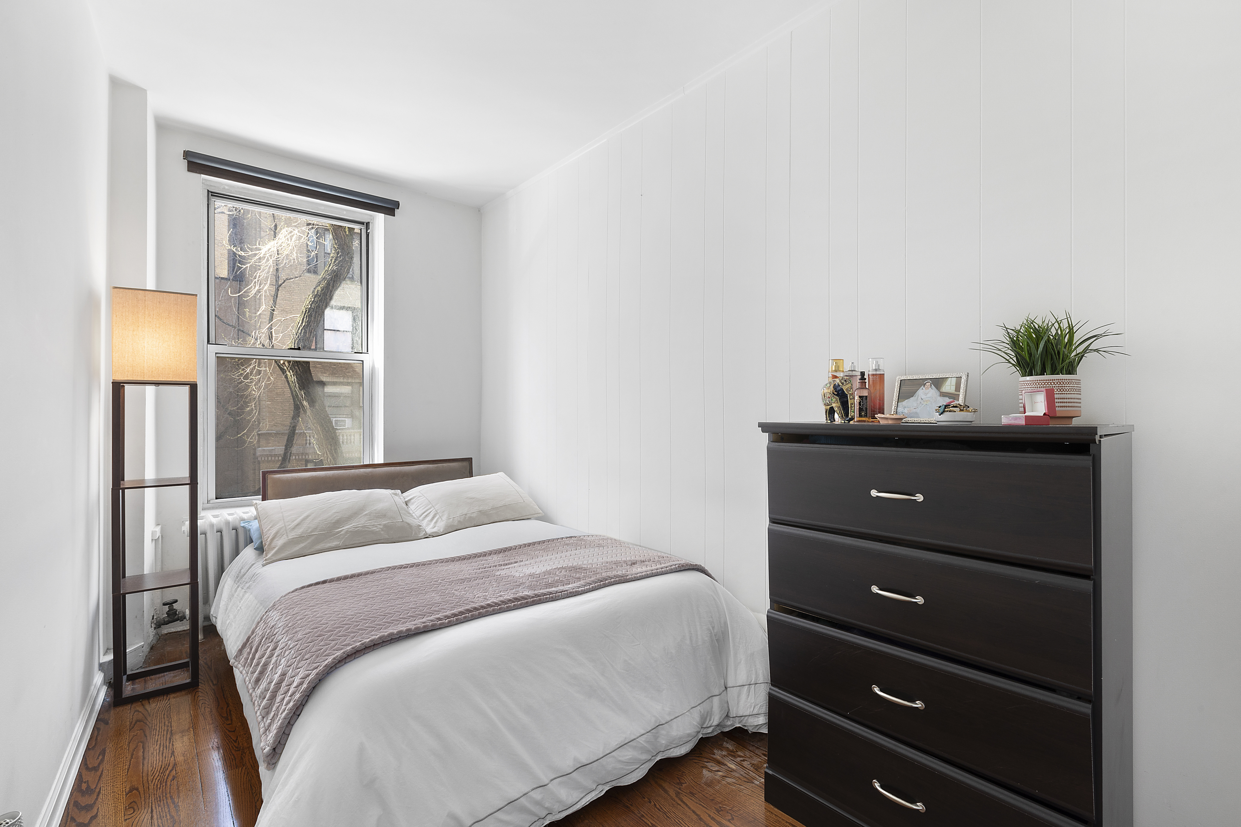 155 West 95th Street, Unit 6 Manhattan, NY 10025 - Photo 3 of 7 a bedroom with a bed and a window