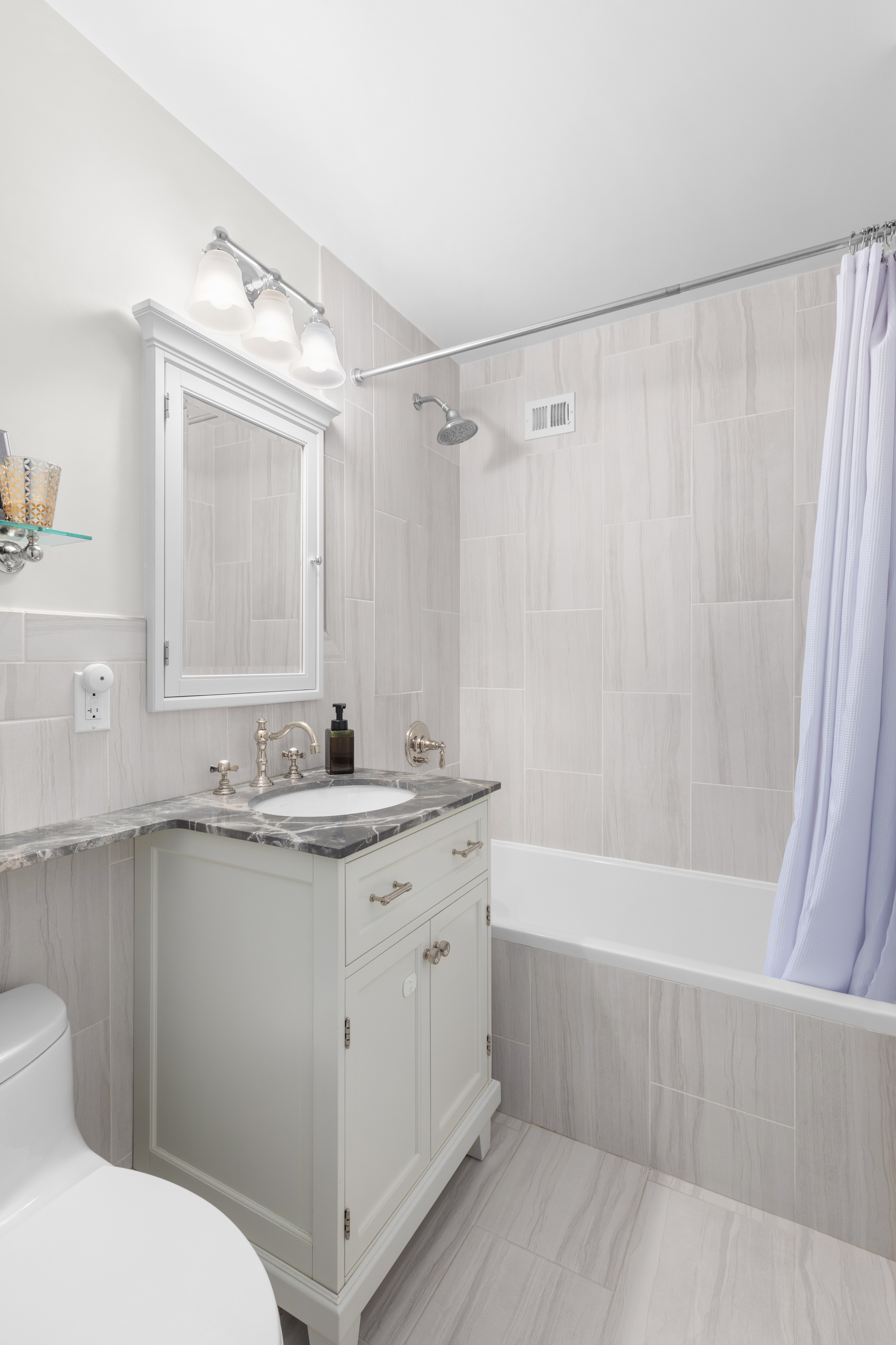 575 Main Street, Unit 509 Manhattan, NY 10044 - Photo 12 of 25 a bathroom with a granite countertop sink a toilet and shower