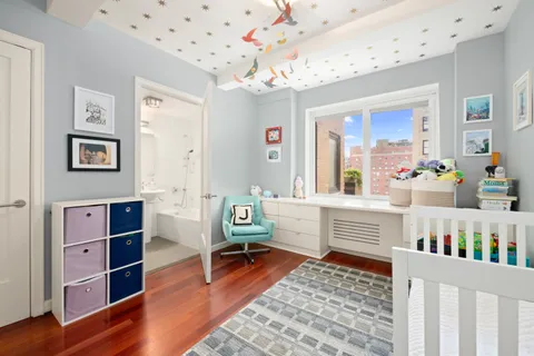 a bedroom with furniture and a rug