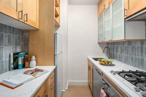 a kitchen with a stove and a white refrigerator