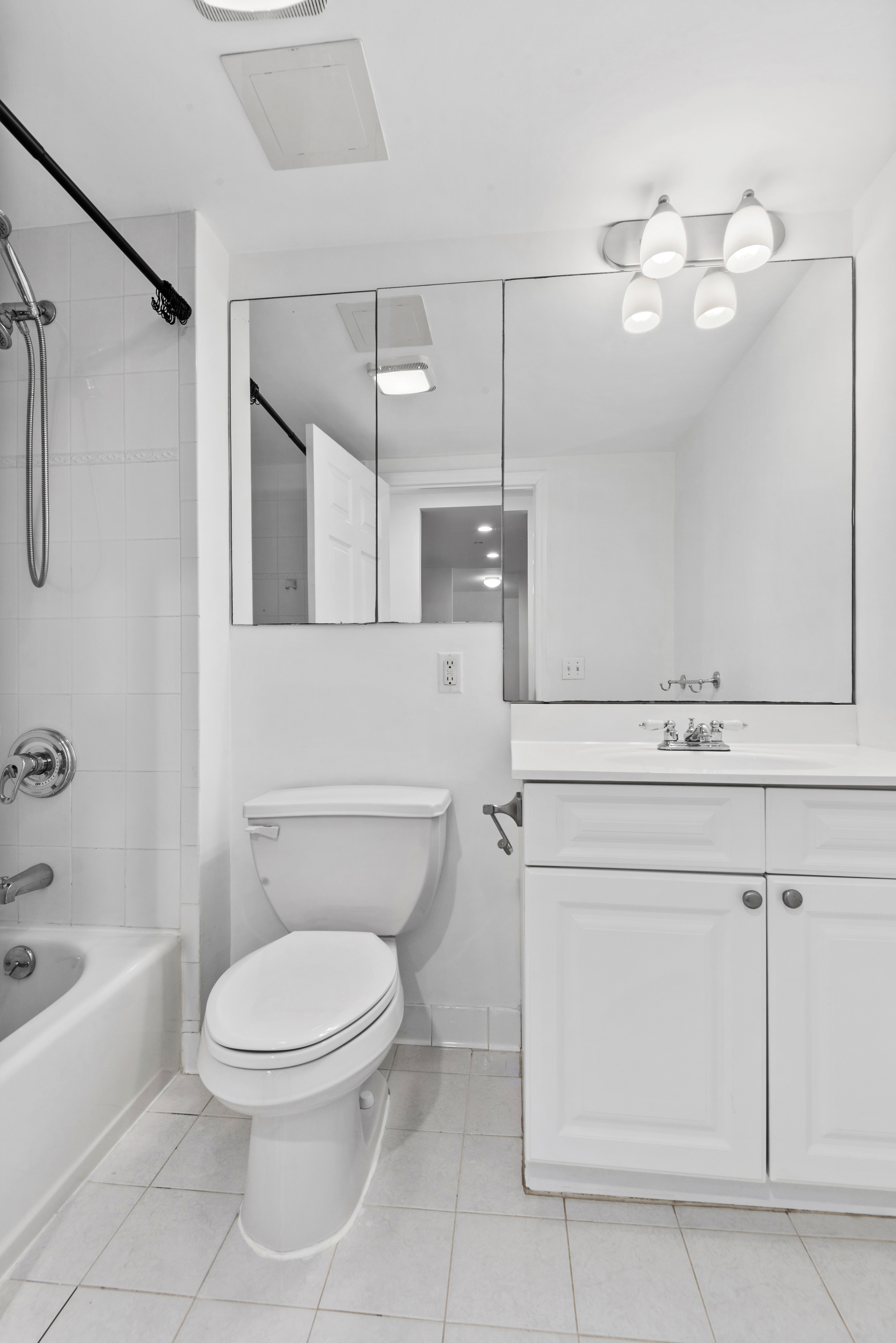 442 97th Street, Unit 1I Brooklyn, NY 11209 - Photo 5 of 11 a bathroom with a toilet sink and mirror