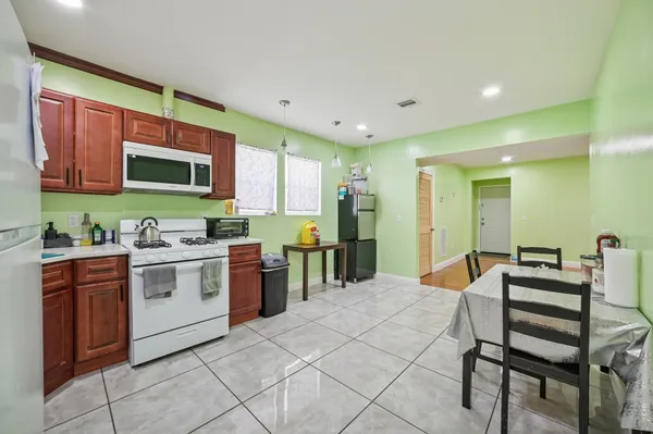 a kitchen with stainless steel appliances kitchen island granite countertop a sink and cabinets