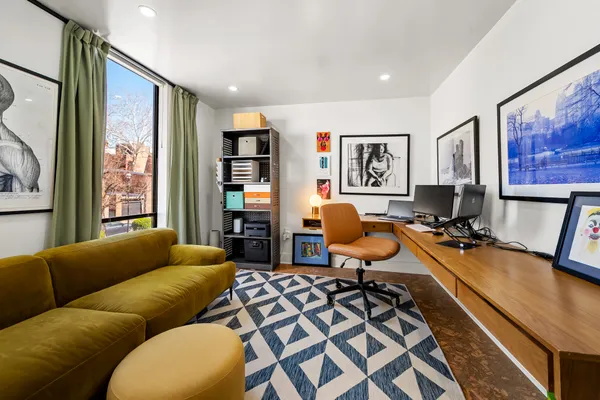 a view of a livingroom with workspace and a couch