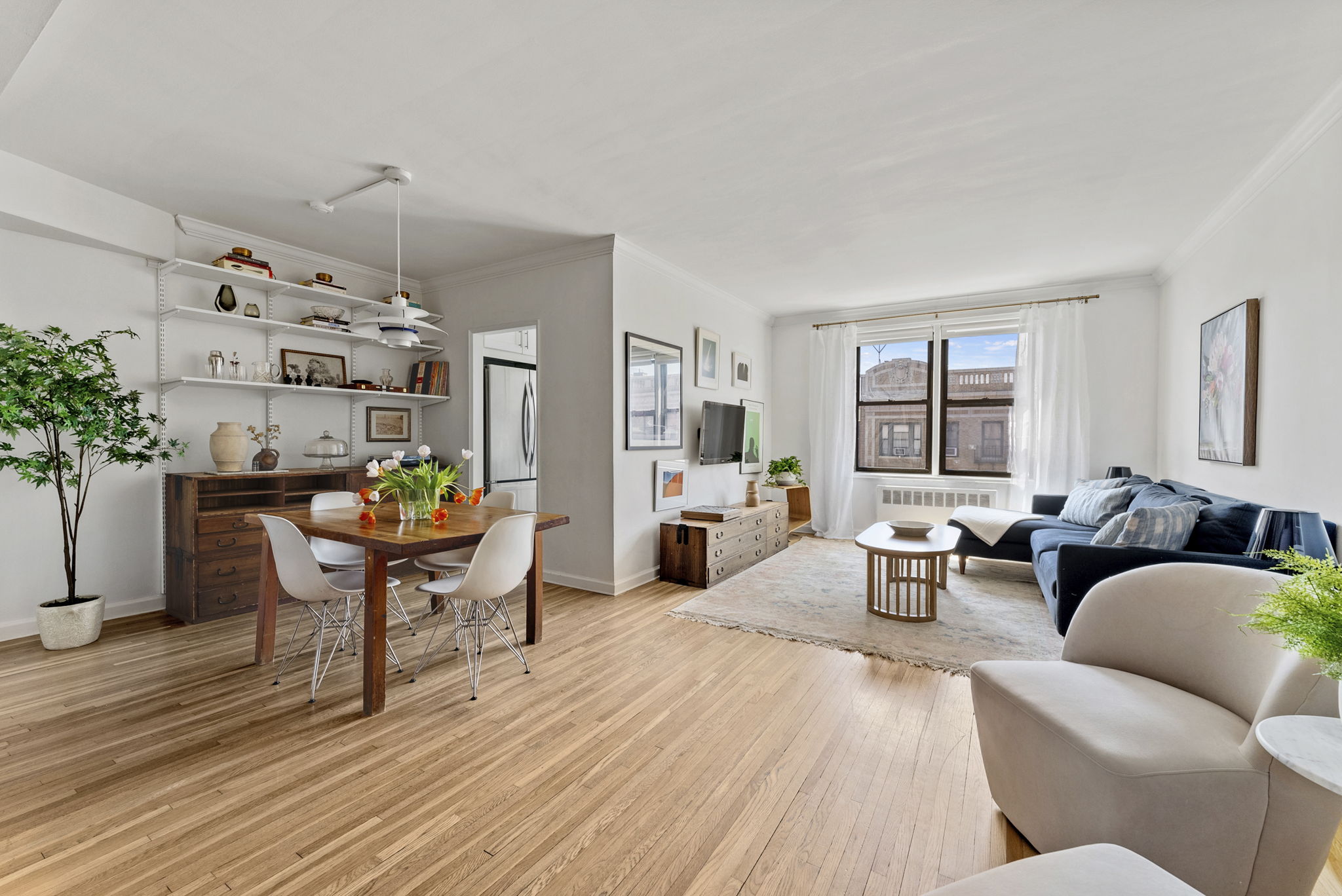 675 Academy Street, Unit 5E Manhattan, NY 10034 - Photo 1 of 10 a living room with furniture a dining table and a potted plant