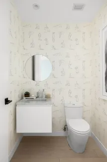 a bathroom with a toilet a sink and mirror
