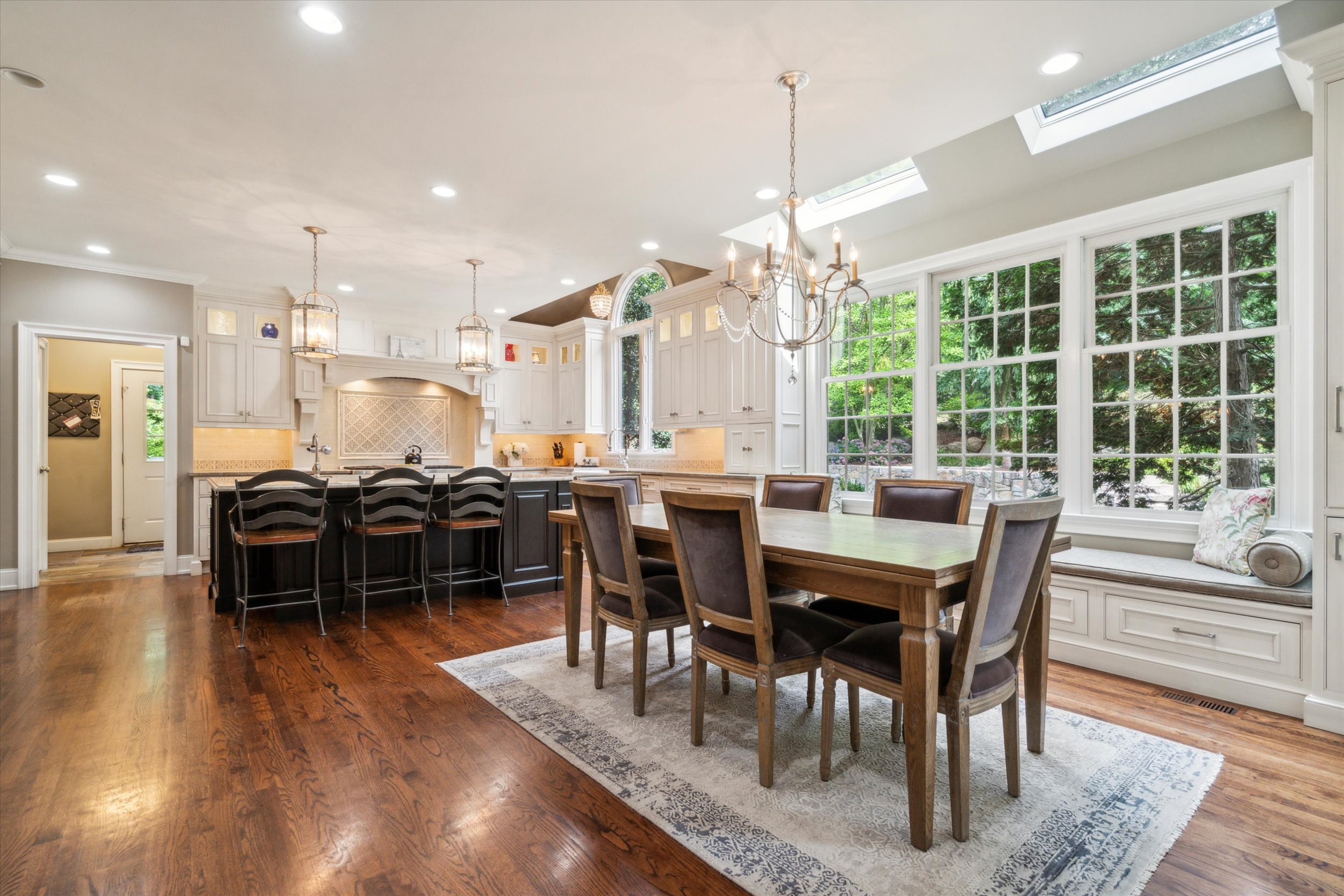145 Biddulph Road Wayne, PA 19087 - Photo 8 of 39 a dining room with wooden floor a chandelier a wooden table and chairs
