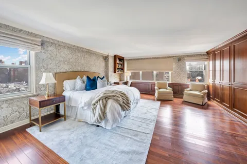 a bedroom with furniture and a wooden floor