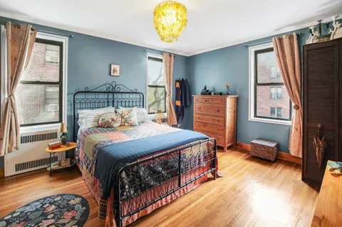 a bedroom with furniture and a window