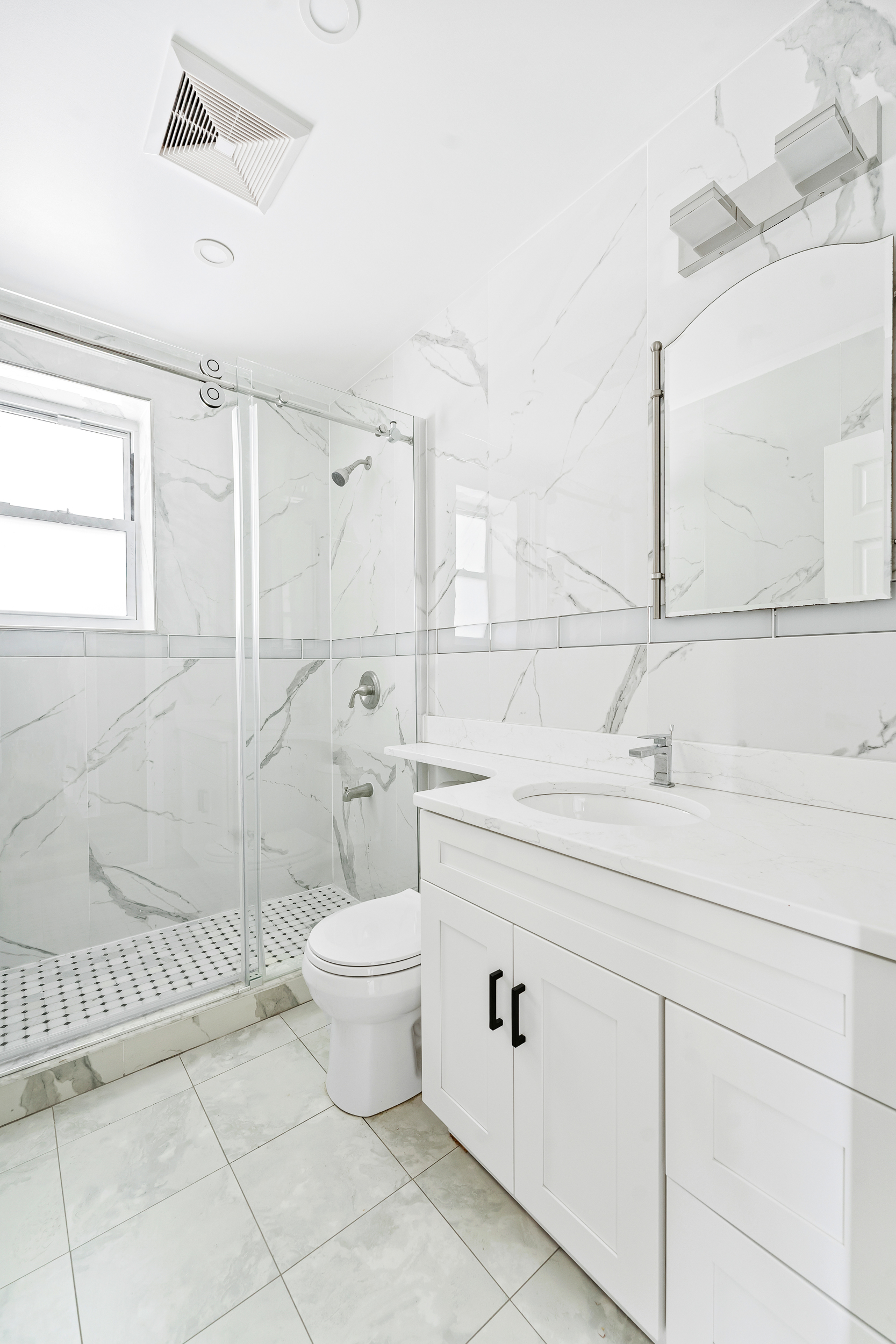 65 Bay 23rd Street, Unit 2 Brooklyn, NY 11214 - Photo 13 of 16 a bathroom with a sink toilet and shower