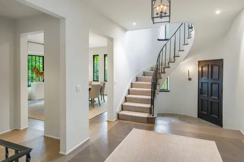 a view of entryway and hall with wooden floor
