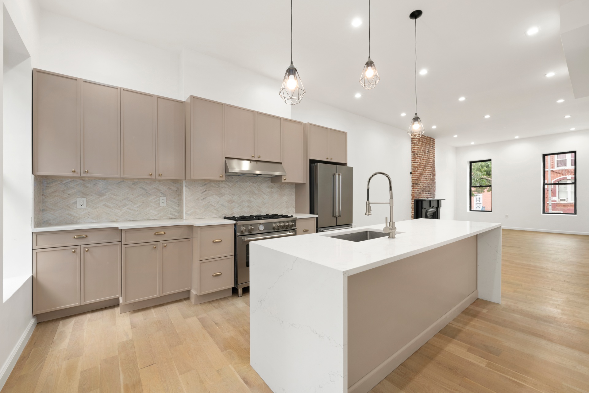 448 Halsey Street, Unit 1 Brooklyn, NY 11233 - Photo 4 of 22 a kitchen with kitchen island a sink stainless steel appliances and cabinets