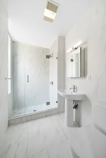 a bathroom with a sink a toilet and mirror