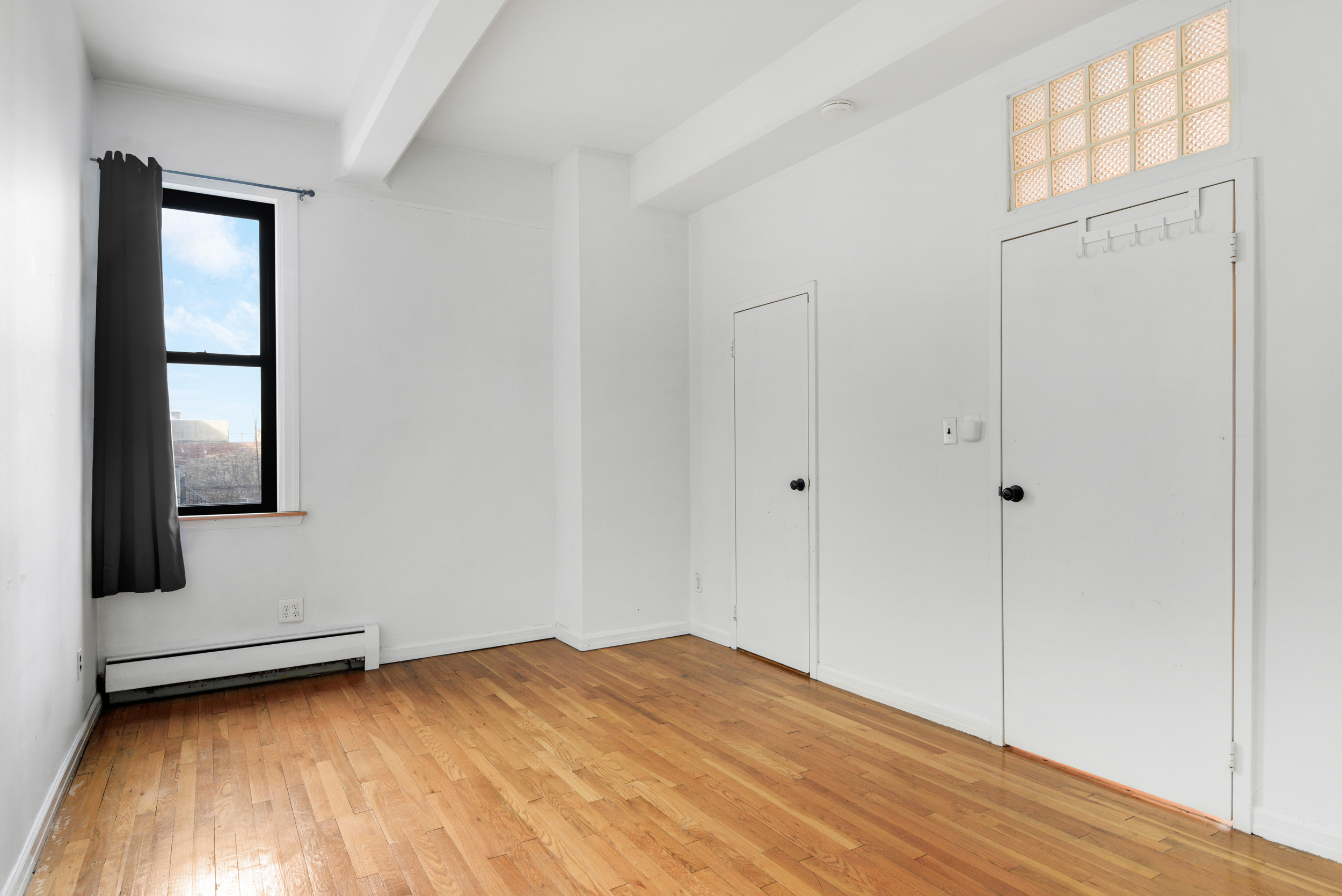 492 Henry Street, Unit 2A Brooklyn, NY 11231 - Photo 5 of 13 a view of a room with wooden floor and cabinet