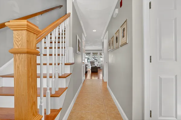 a view of entryway and hall with wooden floor