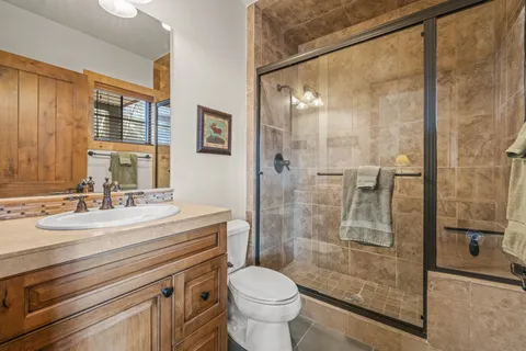 a bathroom with a sink toilet and shower
