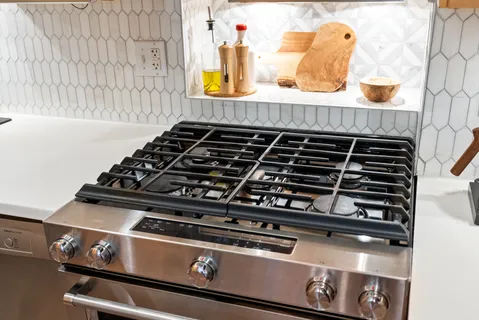 a kitchen with granite countertop a stove and a sink