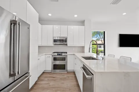 a spacious bedroom with a bed and a large window