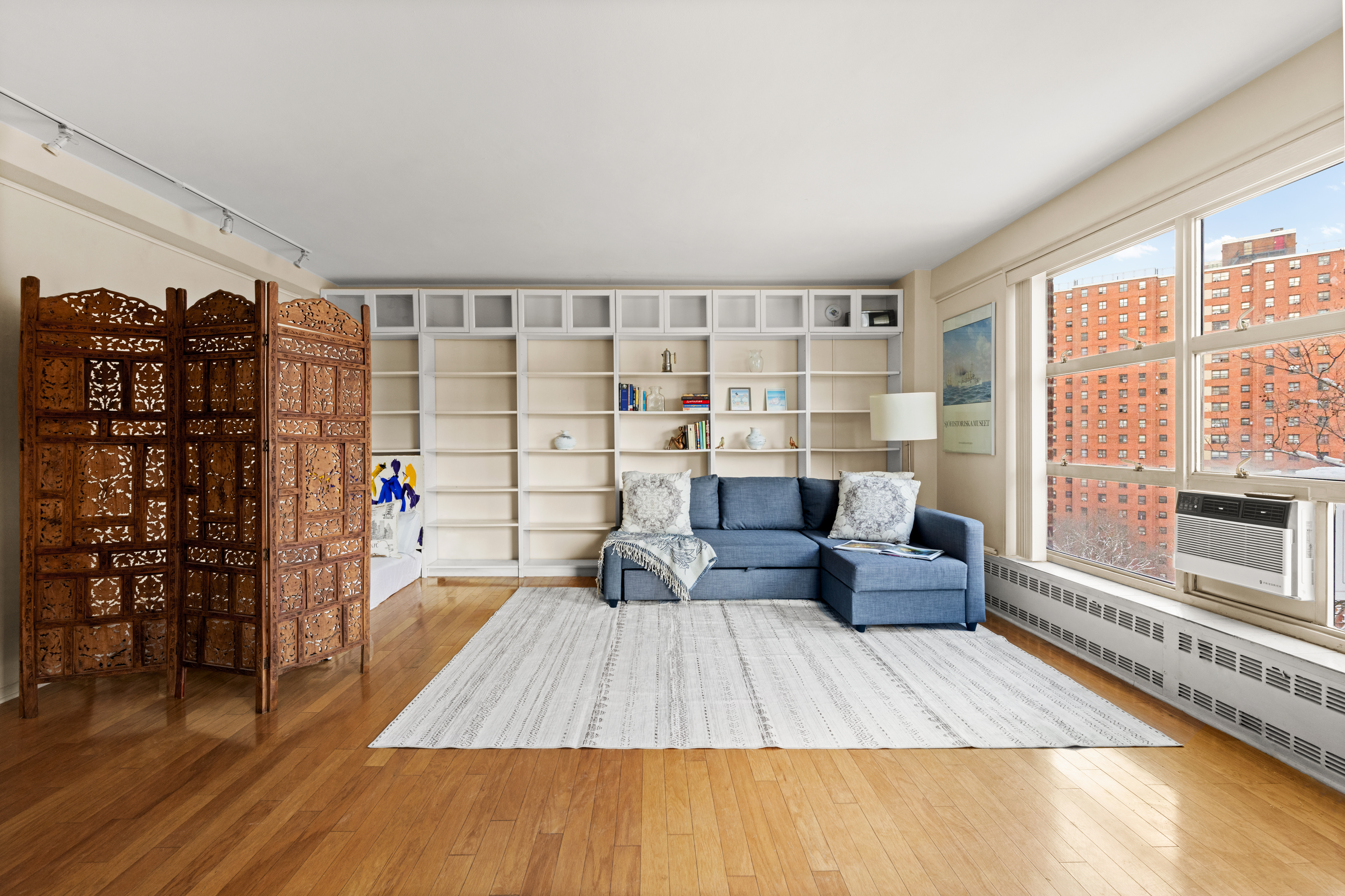 90 La Salle Street, Unit 8E Manhattan, NY 10027 - Photo 2 of 8 a living room with furniture and a floor to ceiling window